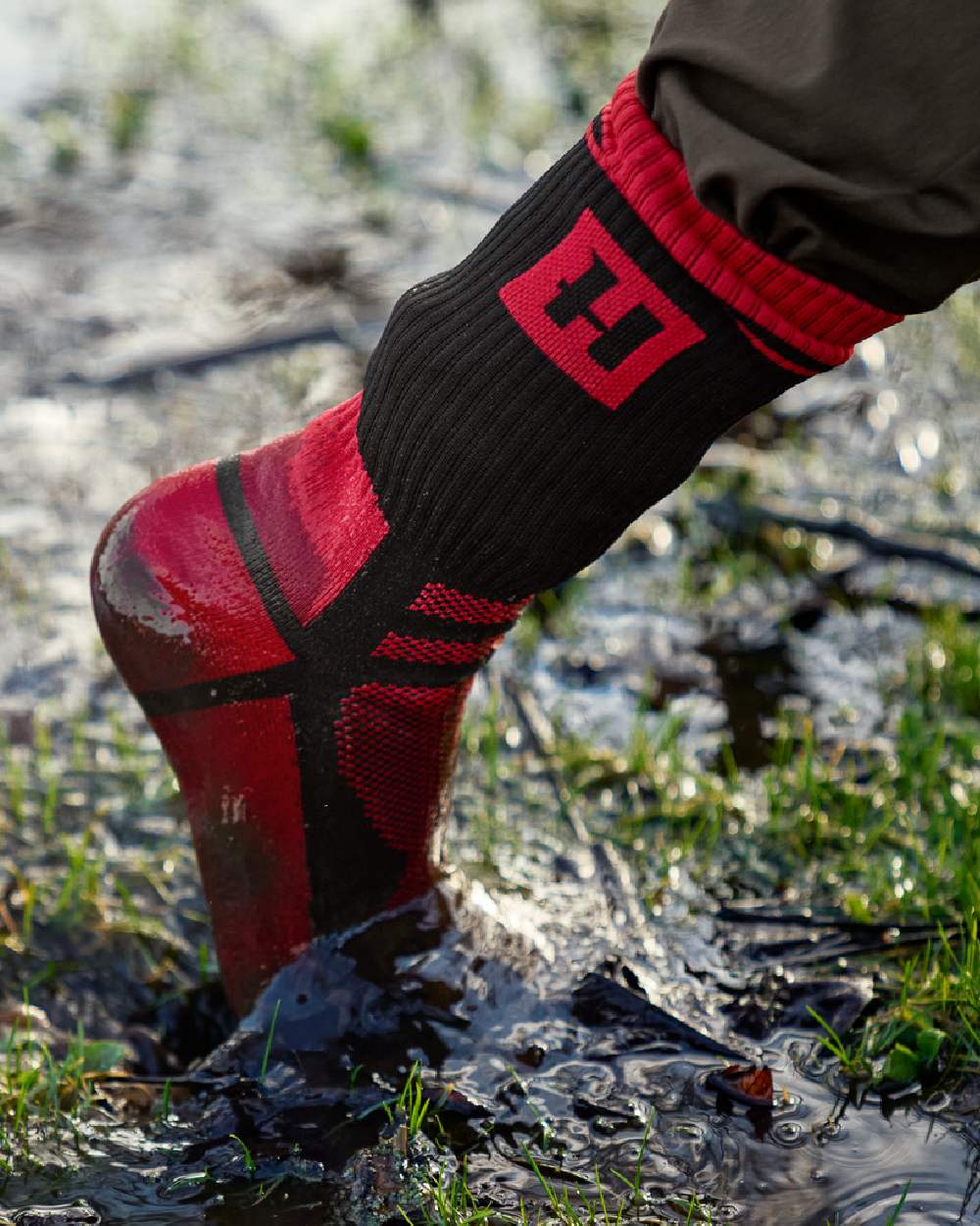 Red Black Coloured Harkila Waterproof Socks on outdoor background