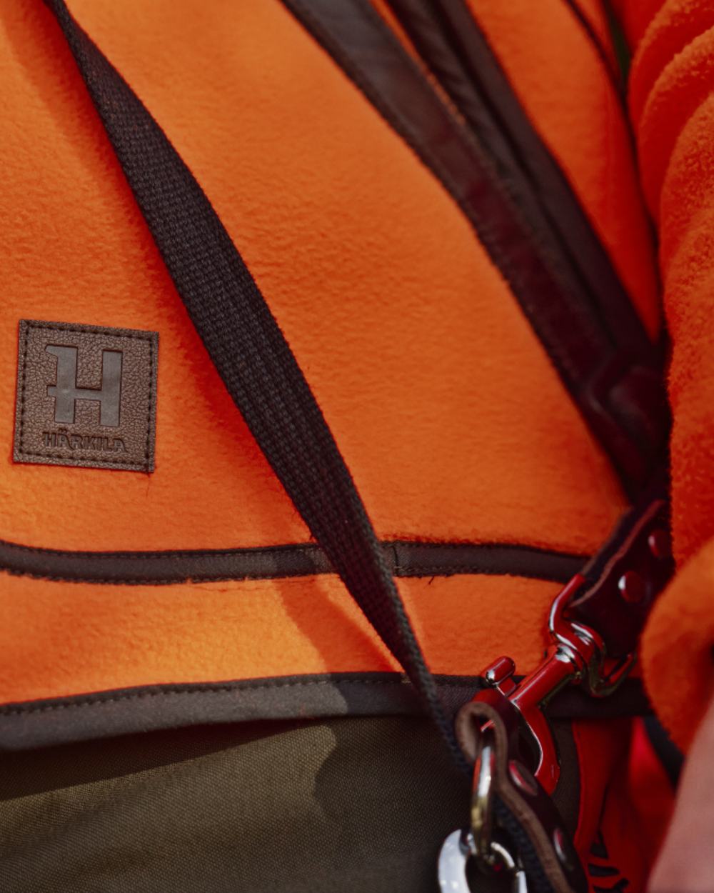 Orange Blaze Coloured Harkila Wildboar Pro Blaze Fleece Jacket on forest background
