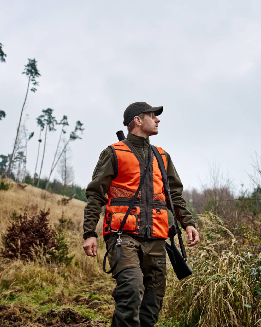 Orange Blaze Brown Coloured Harkila Wildboar Pro Blaze Waistcoat on forest background