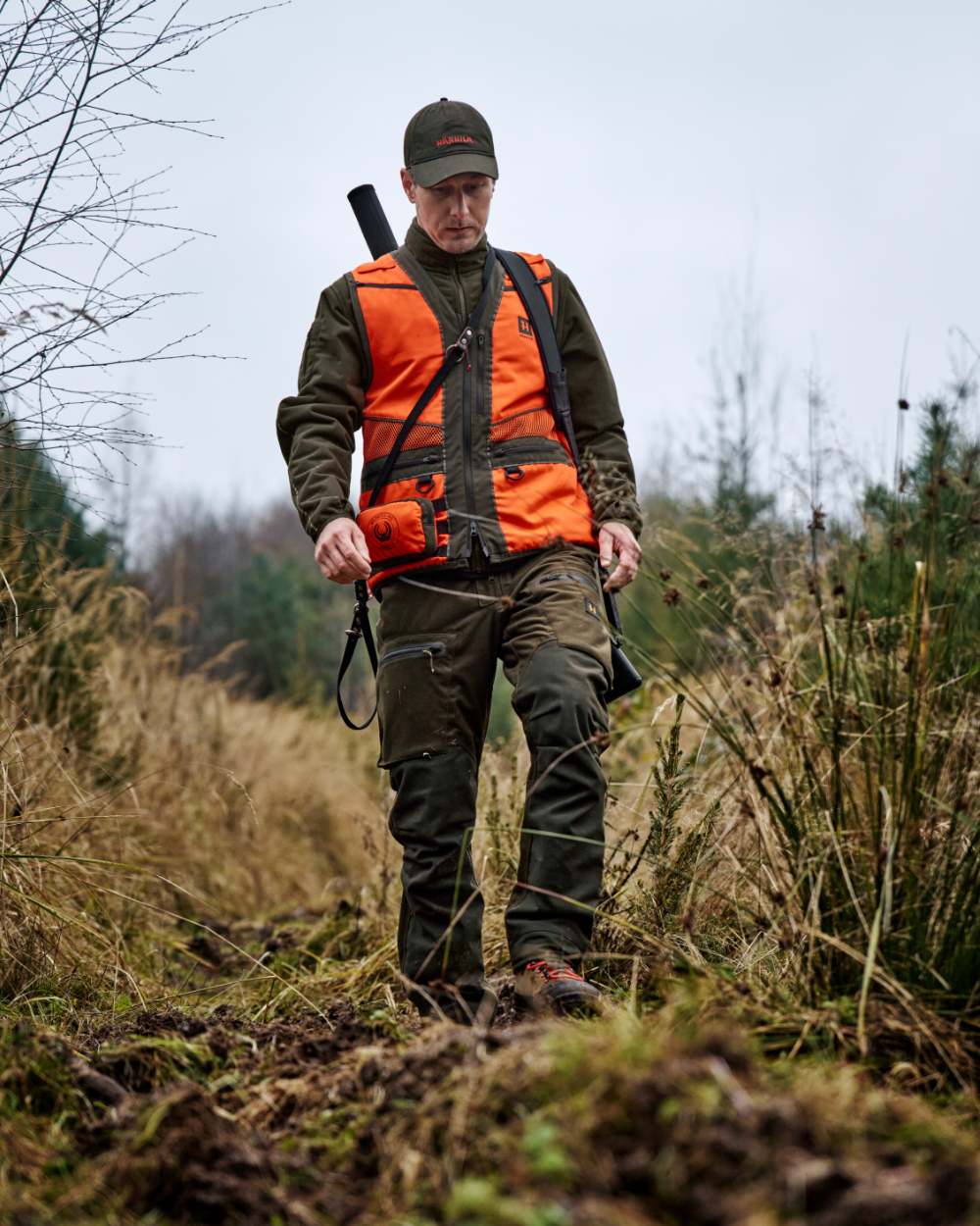 Orange Blaze Brown Coloured Harkila Wildboar Pro Blaze Waistcoat on forest background