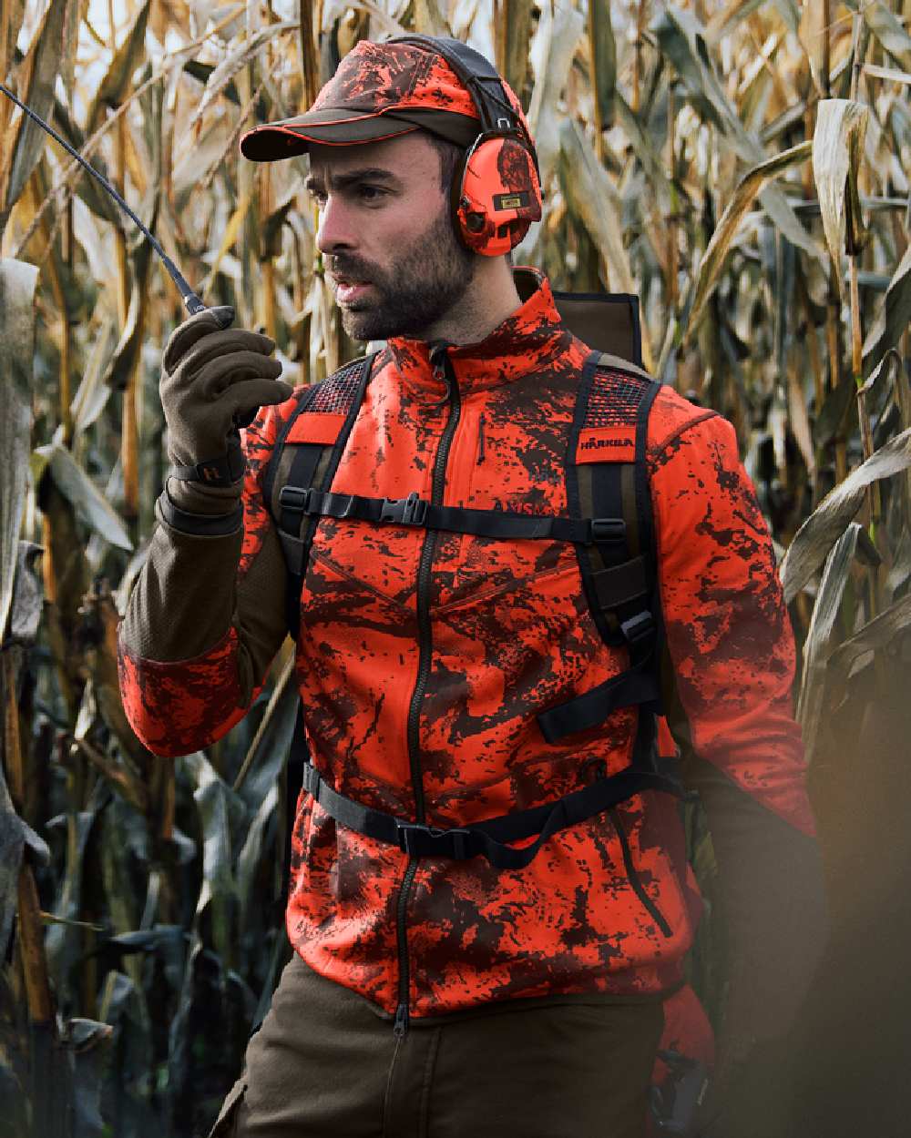 Wildboar Orange Coloured Harkila Wildboar Pro Camo Fleece Jacket on farm background