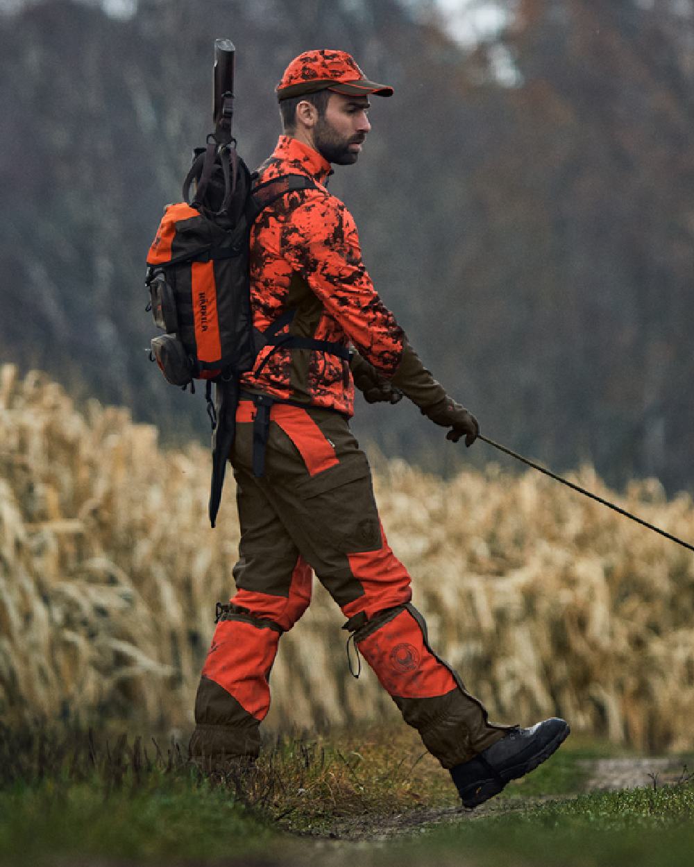 Wildboar Orange Coloured Harkila Wildboar Pro Camo Fleece Jacket on farm background