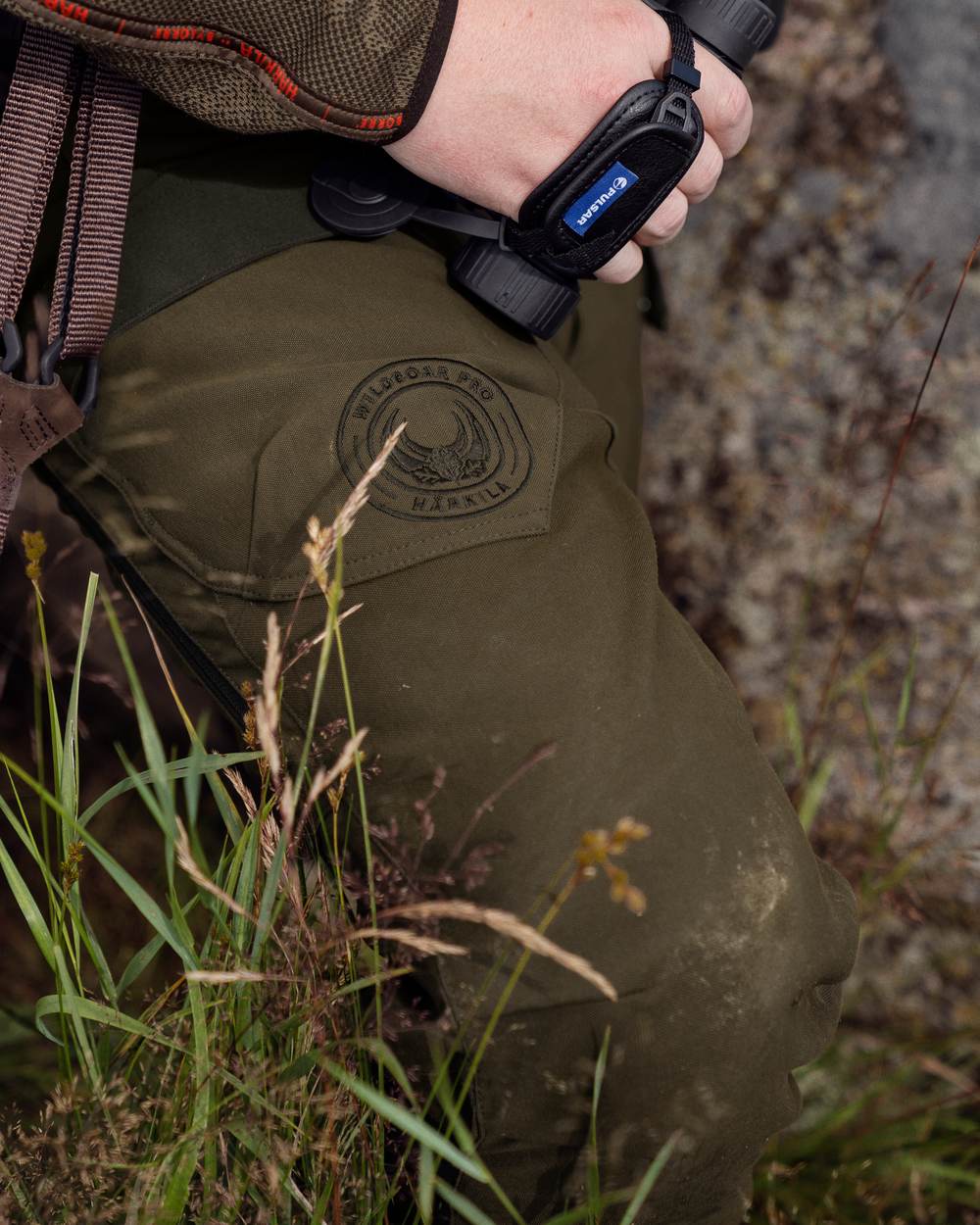 Willow Green Coloured Harkila Wildboar Pro Move Trousers on outdoor background