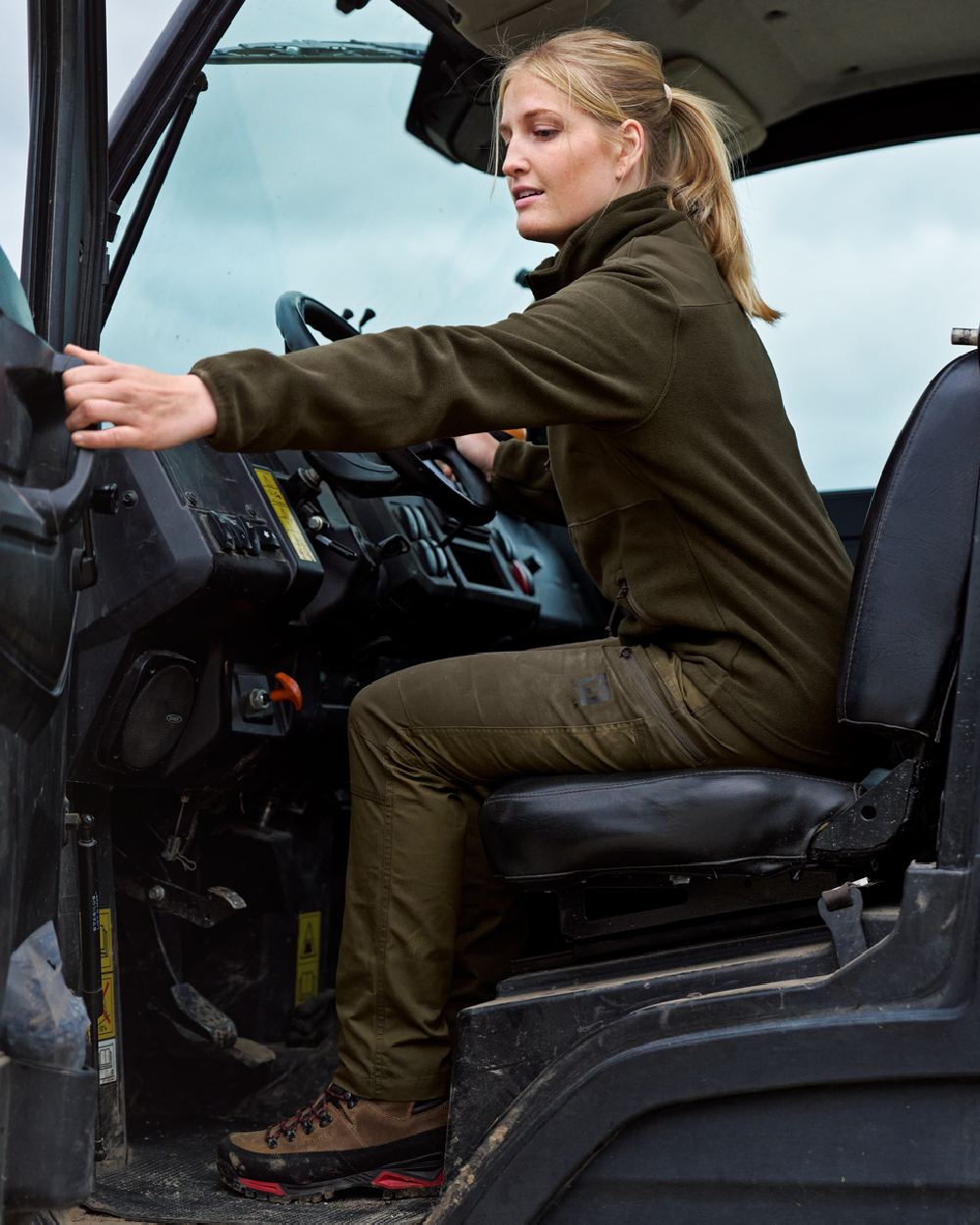 Dark Olive Willow Green Coloured Harkila Womens Fjell Trousers on tractor background
