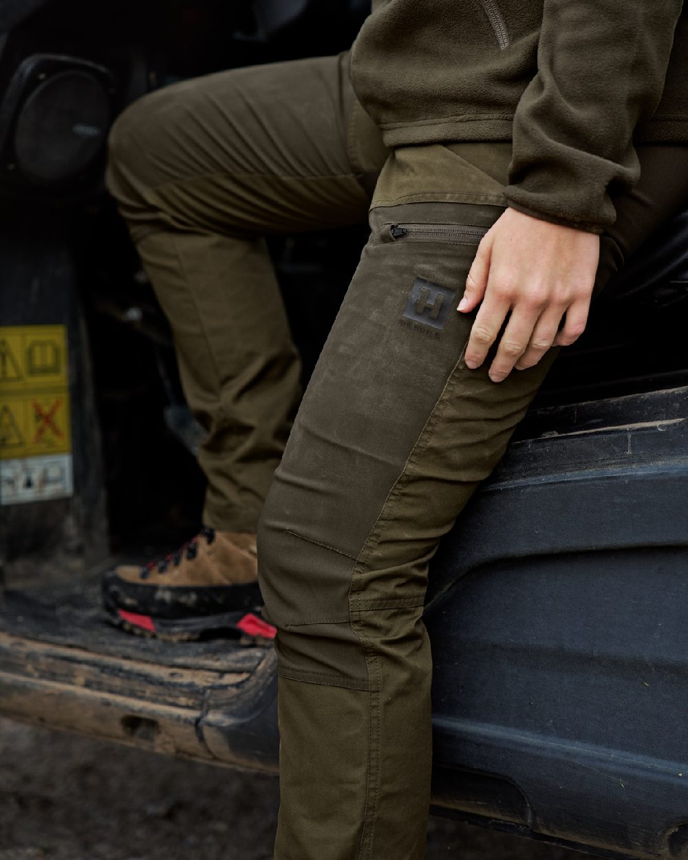 Dark Olive Willow Green Coloured Harkila Womens Fjell Trousers on tractor background