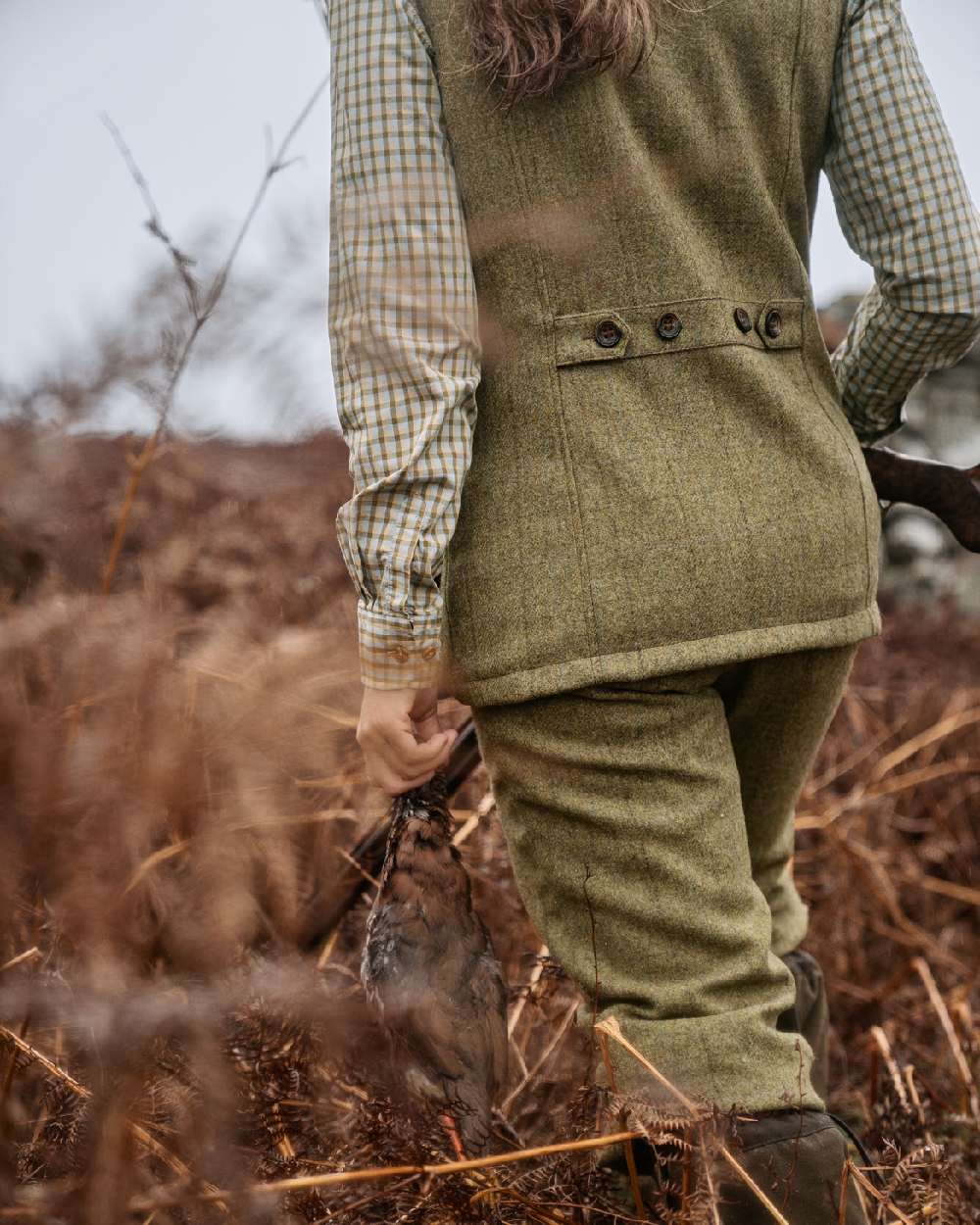 Olive Coloured Harkila Womens Jura Waistcoat on forest background