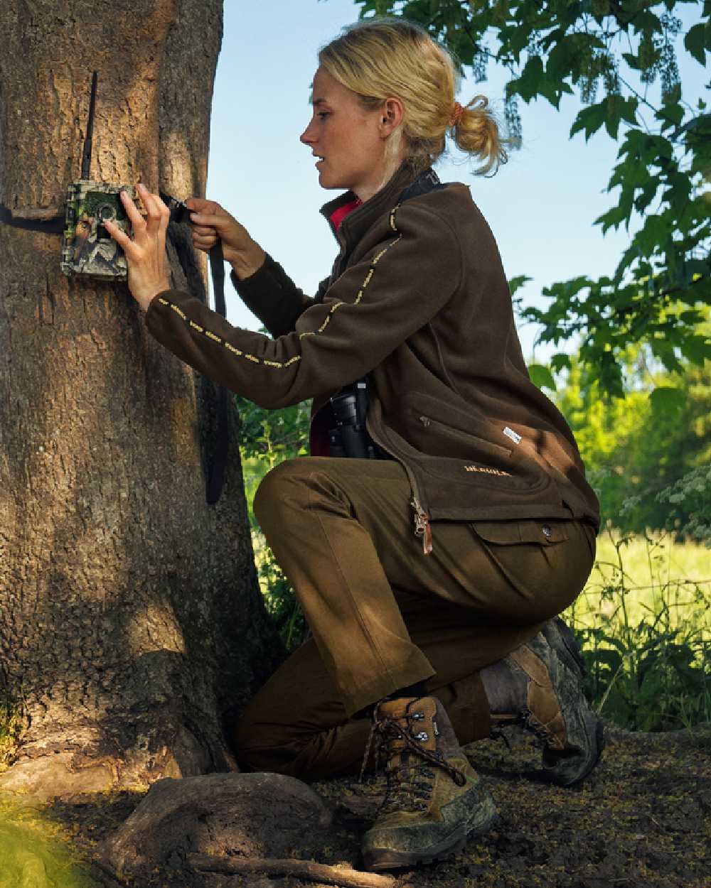 Brown Red Coloured Harkila Womens Kamko Reversible Windstopper Fleece Jacket on outdoor background