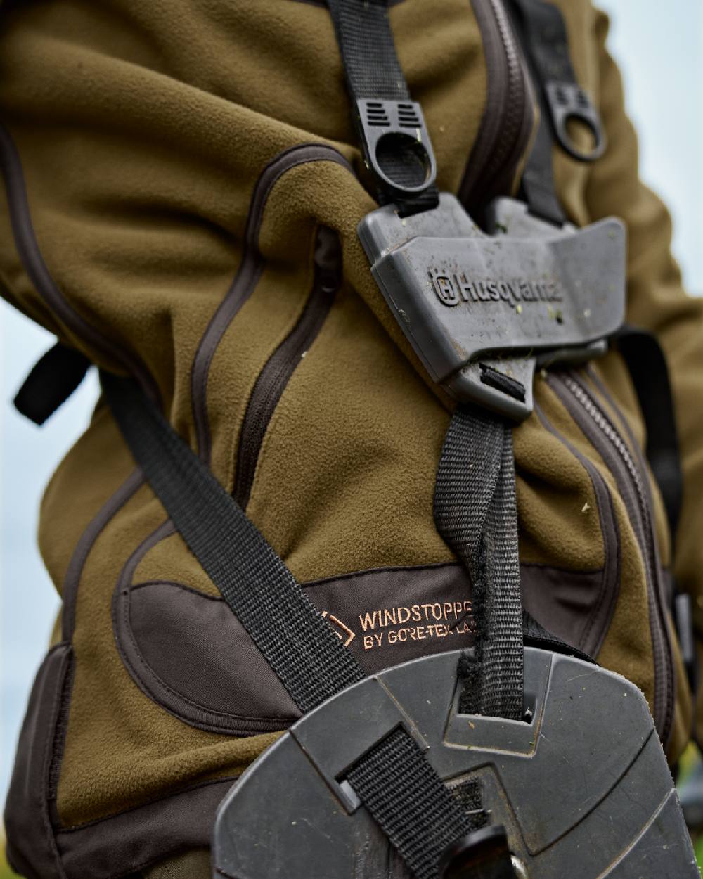 Dark Olive Arabian Spice Coloured Harkila Womens Kamko Reversible Windstopper Fleece Jacket on outdoor background