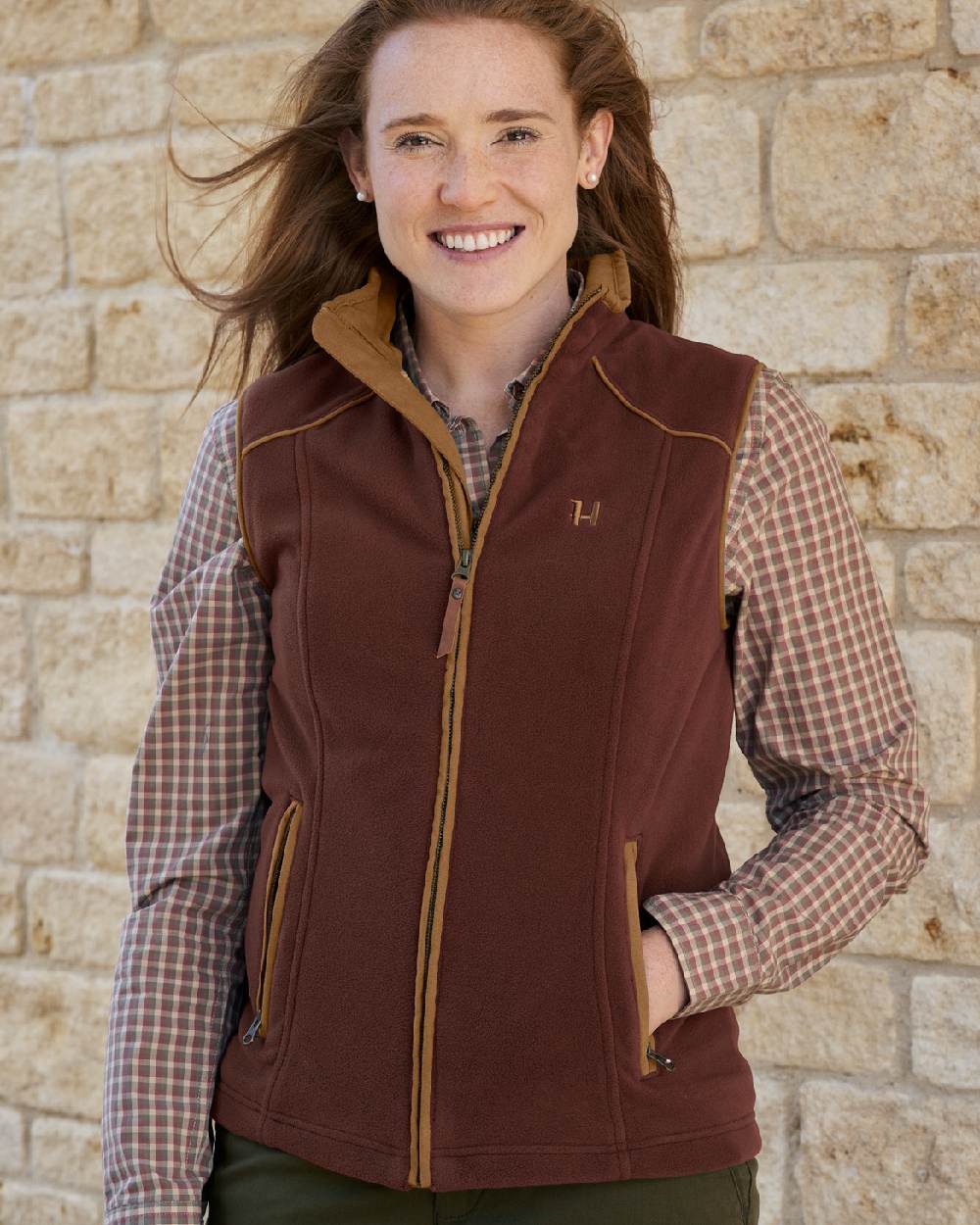 Burgundy Coloured Harkila Womens Sandhem 200 Fleece Waistcoat on outdoor background