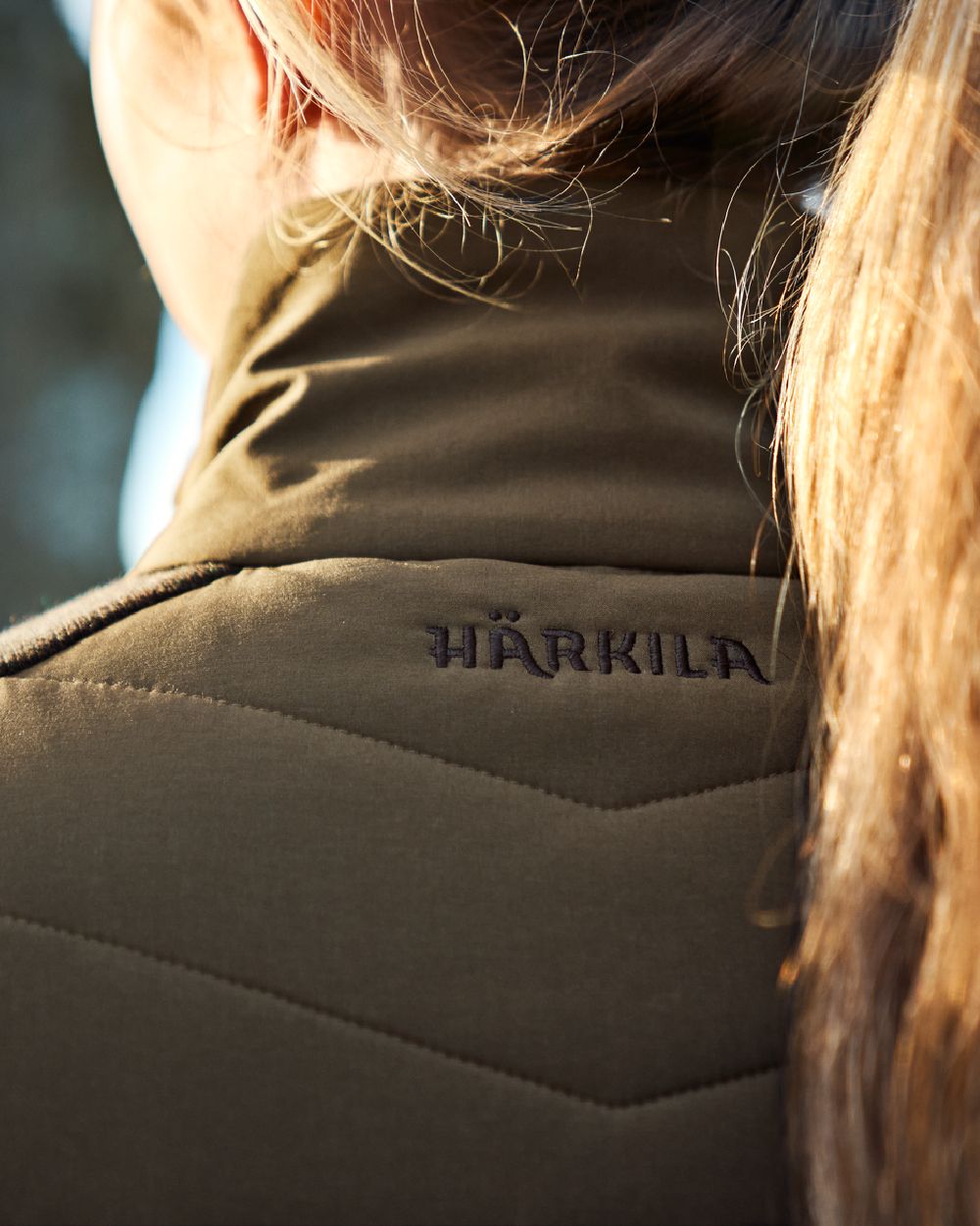 Willow Green Coloured Harkila Womens Sandhem Pro Insulated Cardigan on blurry background
