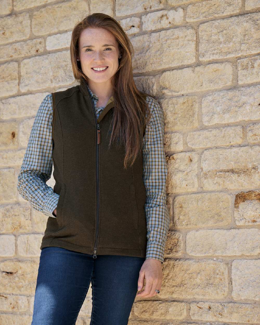 Forest Green Coloured Harkila Womens Sandhem Pro Waistcoat on wall background