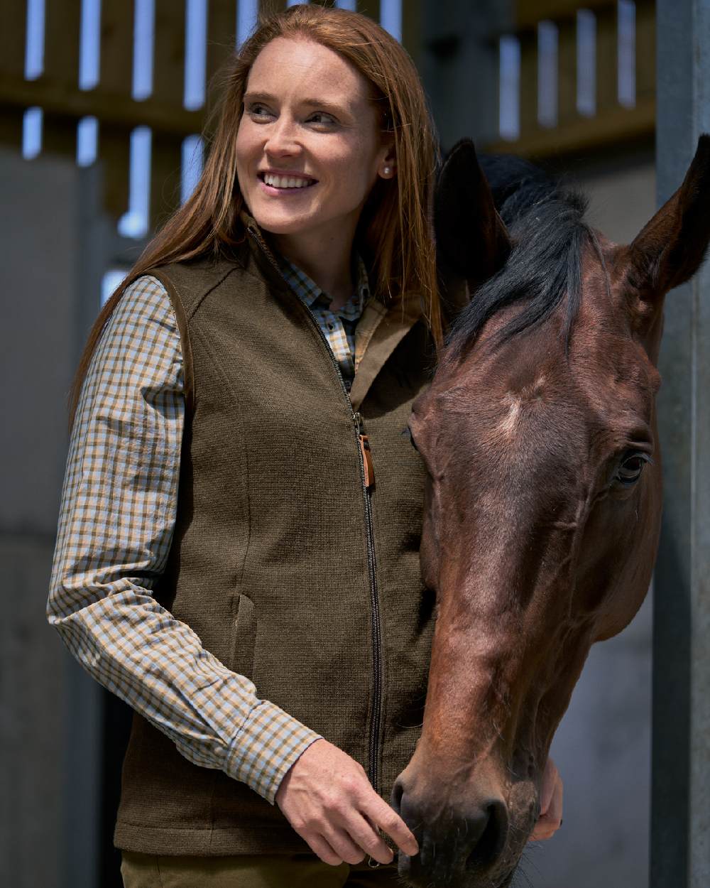 Forest Green Coloured Harkila Womens Sandhem Pro Waistcoat on outdoor background