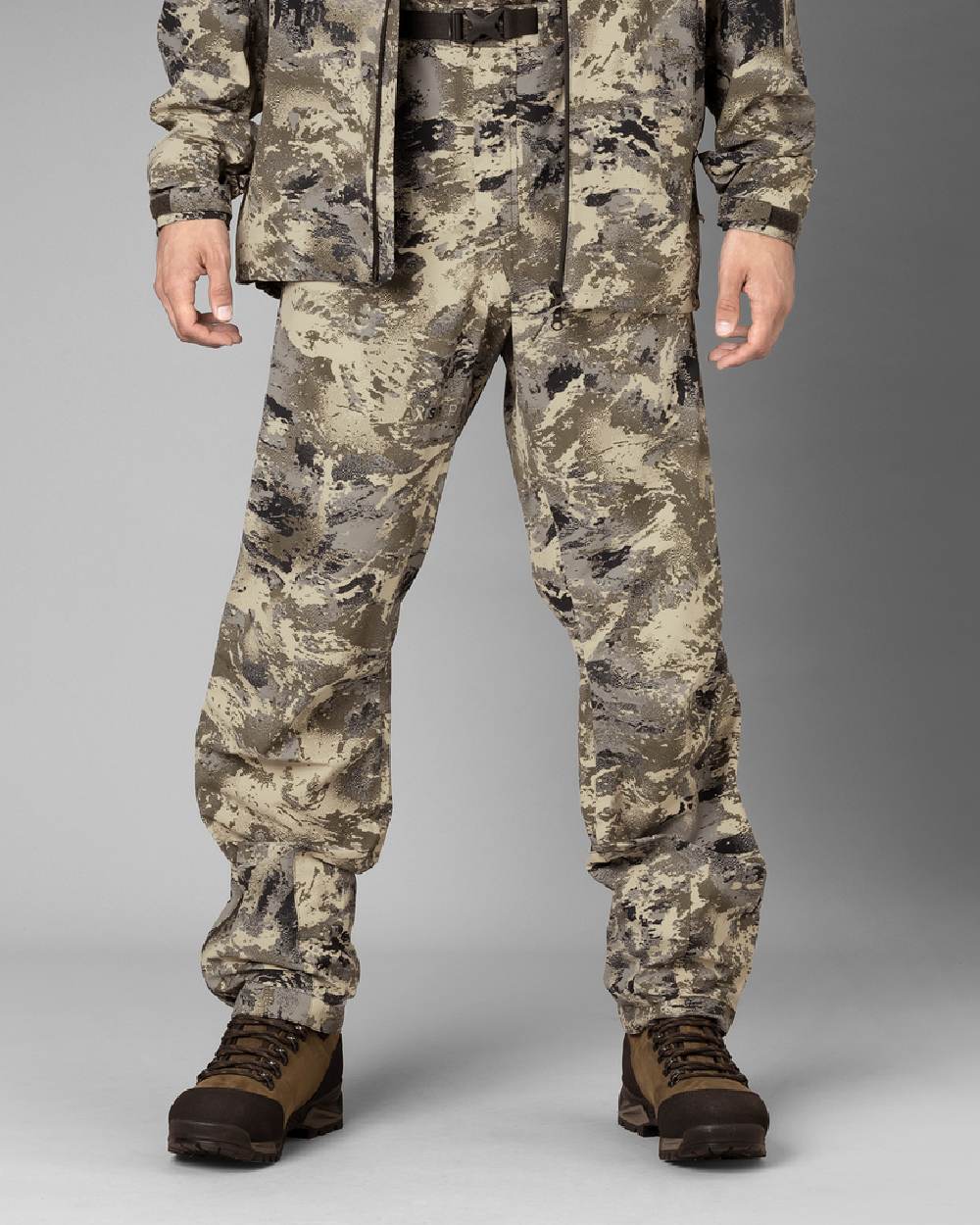 AXIS Mountain coloured Harkila Mountain Hunter Expedition HWS Packable Trousers on grey baclground