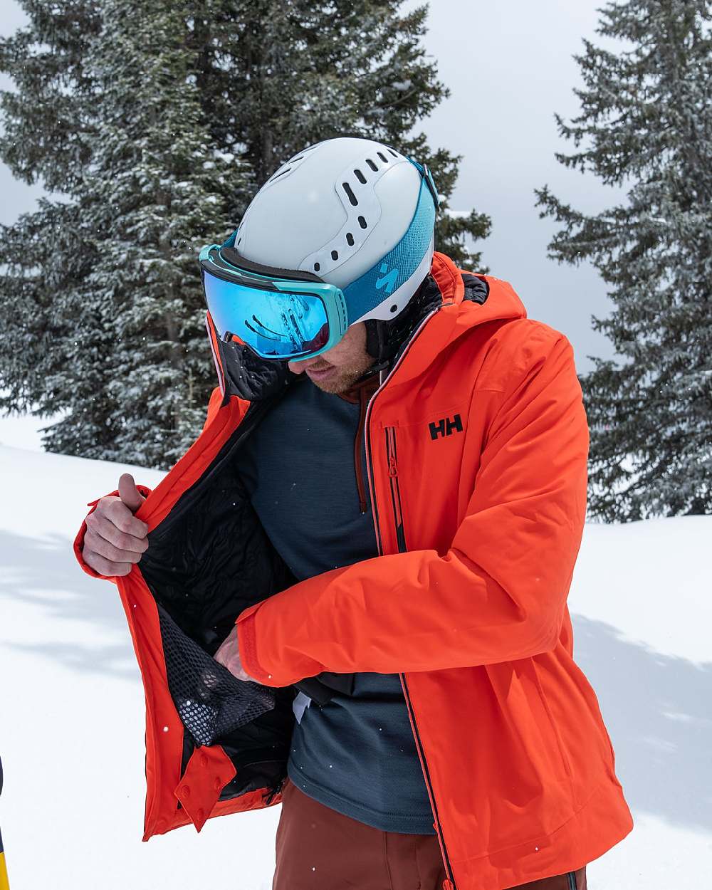 Iron Oxide Coloured Helly Hansen Mens Alpha Lifaloft Insulated Ski Pants on snow background