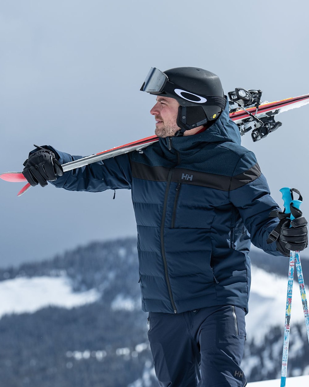 Navy Coloured Helly Hansen Mens Alpha Lifaloft Insulated Ski Pants on snow background