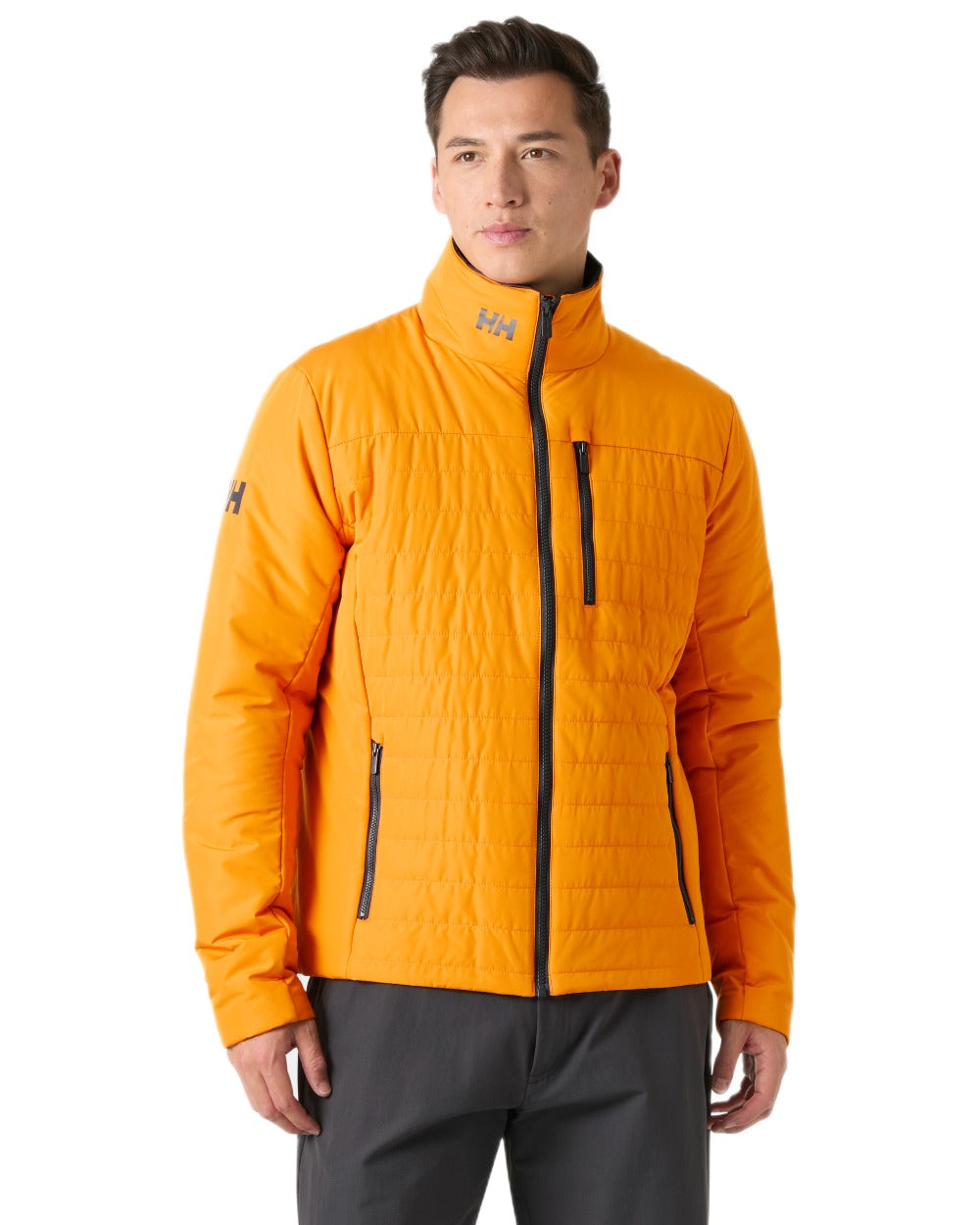 Ignite Orange coloured Helly Hansen Mens Crew Insulated Sailing Jacket 2.0 on white background