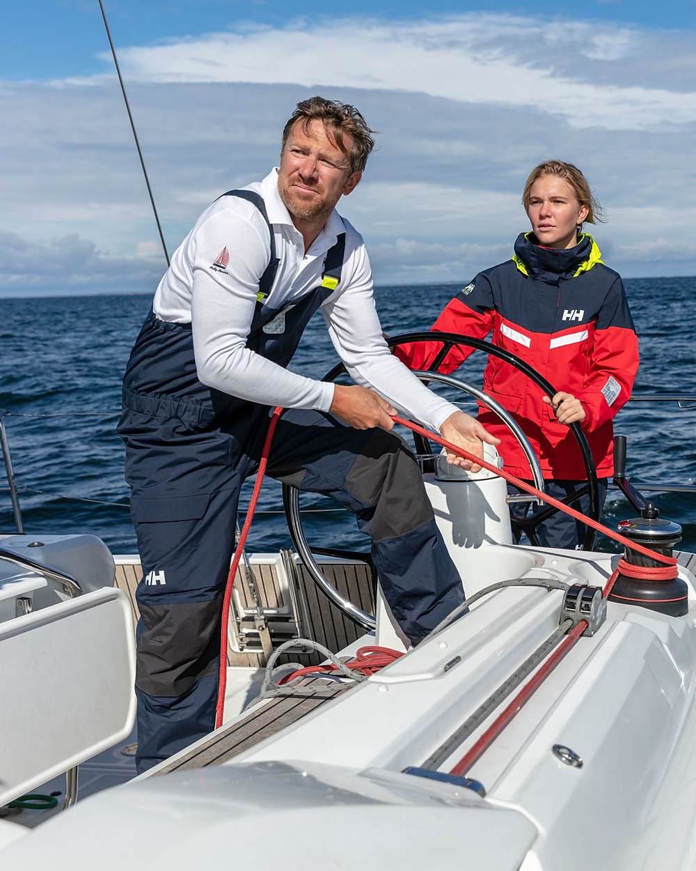 Navy coloured Helly Hansen Mens Pier 4.0 Bib on sea background