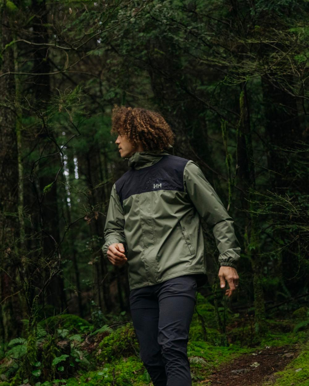 Lav Green coloured Helly Hansen Mens Vancouver Rain Jacket on forest background