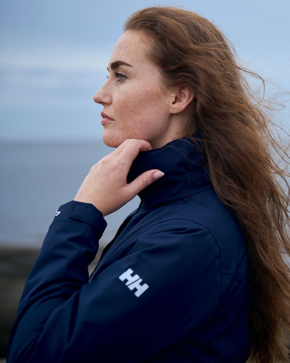 Navy coloured Helly Hansen Womens Aden Long Rain Coat on white background