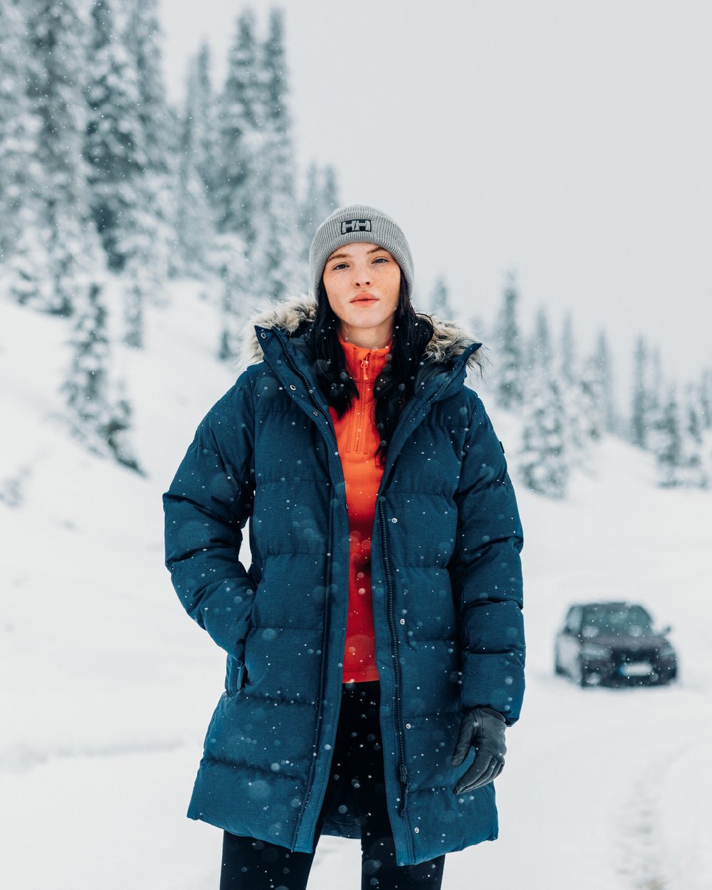 Navy Coloured Helly Hansen Womens Blossom Puffy Winter Parka on snow background