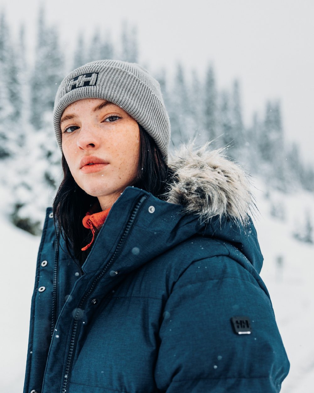 Navy Coloured Helly Hansen Womens Blossom Puffy Winter Parka on snow background