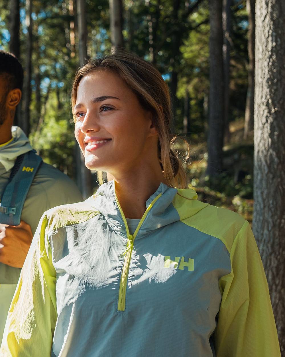 Sharp Green coloured Helly Hansen Womens Roam Wind Anorak on forest background