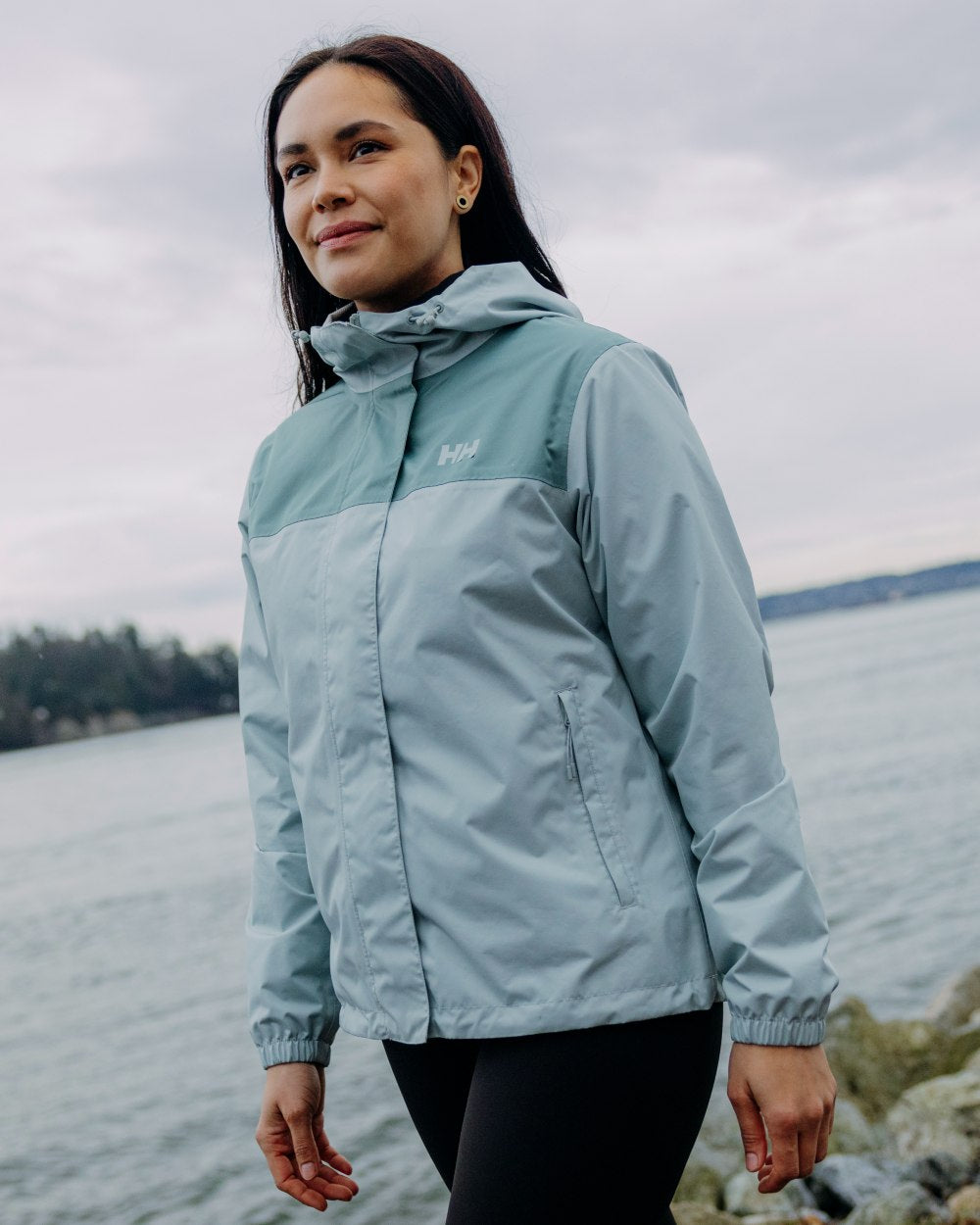 Green Mist coloured Helly Hansen Womens Vancouver Rain Jacket on sea background