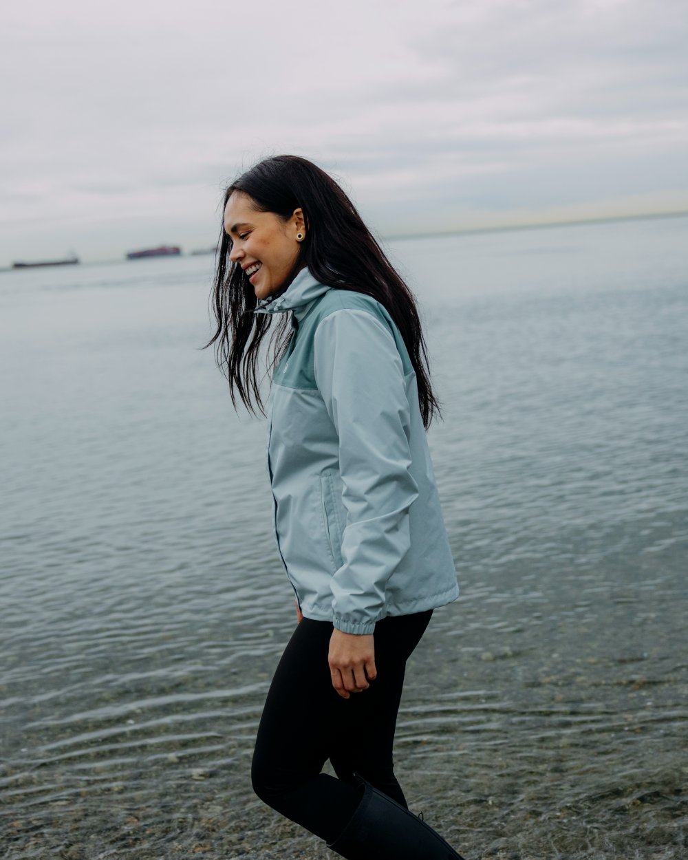 Green Mist coloured Helly Hansen Womens Vancouver Rain Jacket on sea background