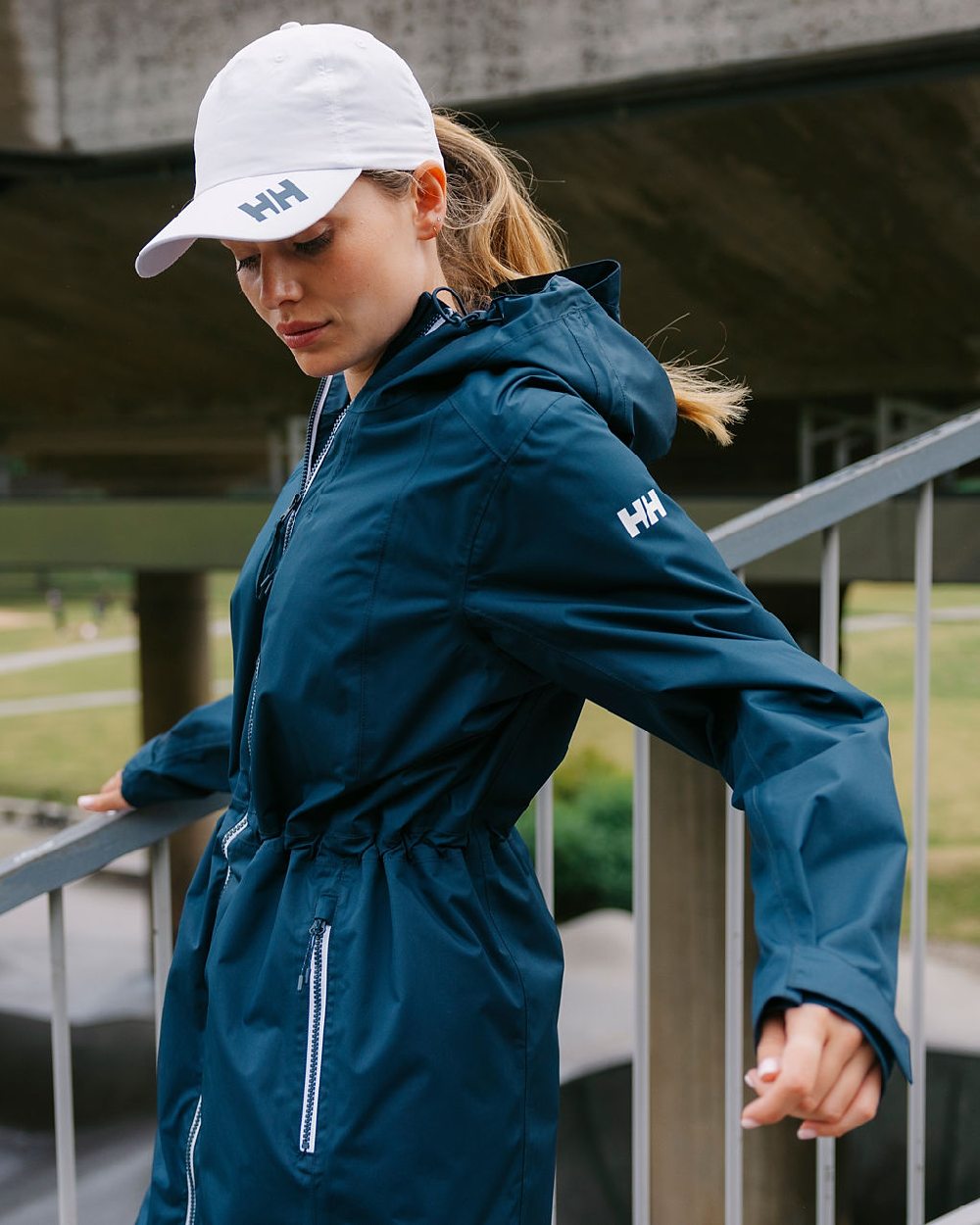 Navy coloured Helly Hansen Womens Westport Raincoat on street background