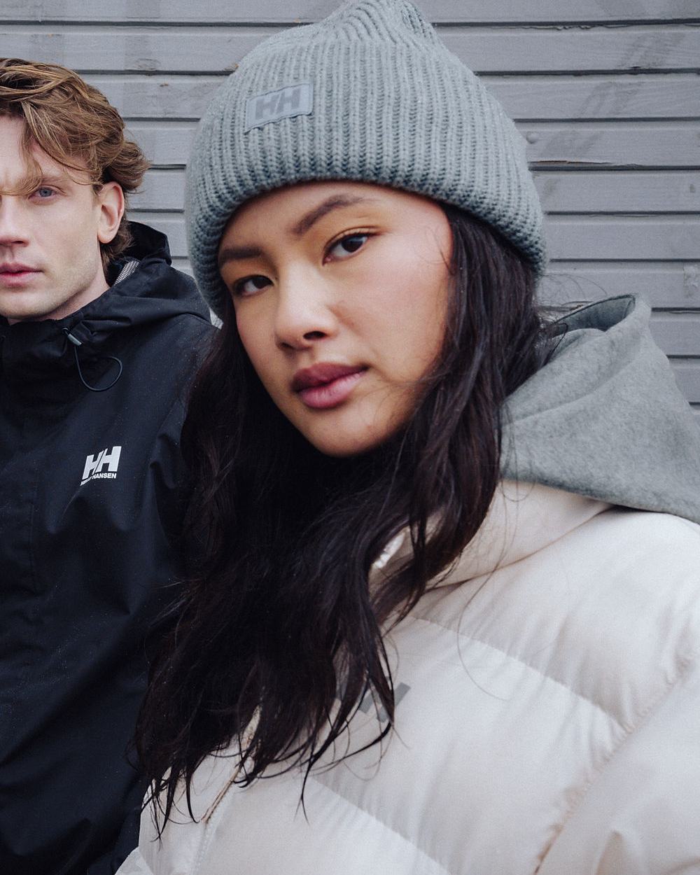 Cream Coloured Helly Hansen Womens YU 23 Reversible Puffer Jacket on outdoor background