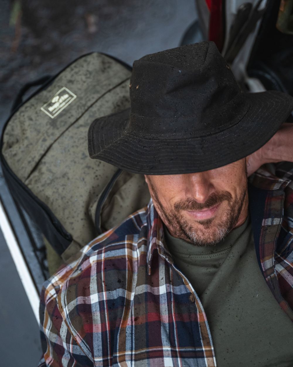 Antique Olive Coloured Hoggs of Fife Caledonia Waxed Hat on outdoor background