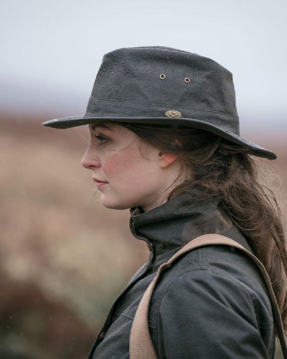 Antique Olive Coloured Hoggs of Fife Caledonia Waxed Hat on blurry background
