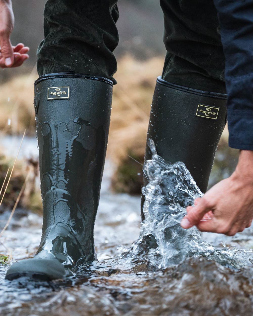 Field Green Coloured Hoggs of Fife Field Sport Neoprene Lined Wellingtons on water background