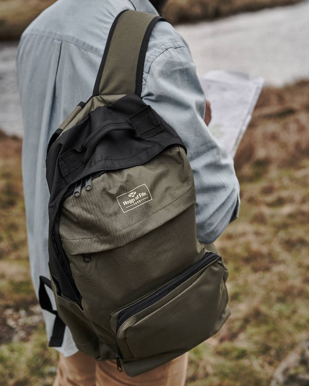 Green Black Coloured Hoggs of Fife Field & Trek Backpack on blurry background