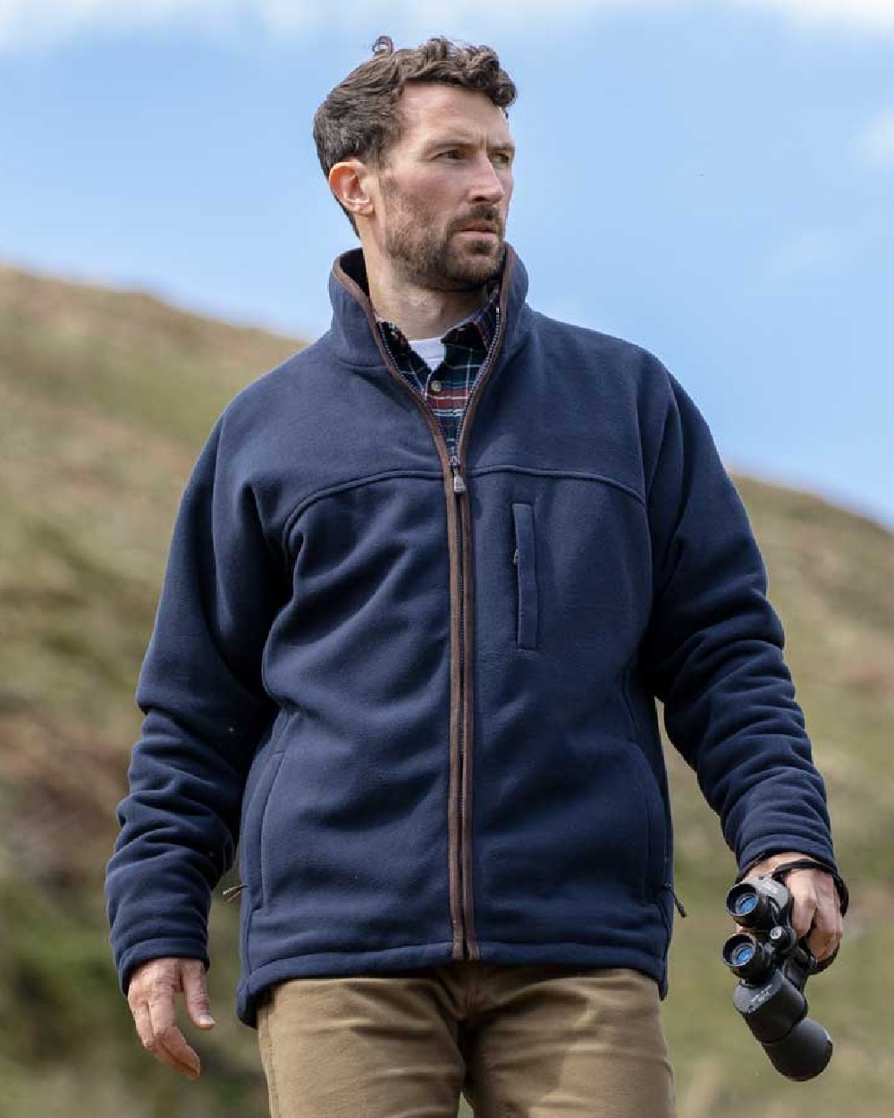 Navy Coloured Hoggs of Fife Ghillie II Padded Waterproof Fleece Jacket on blurry background