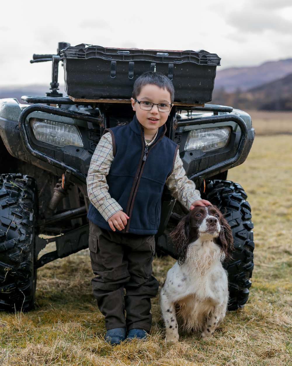 Dark Green Coloured Hoggs of Fife Junior Struther Waterproof Trousers on tractor background