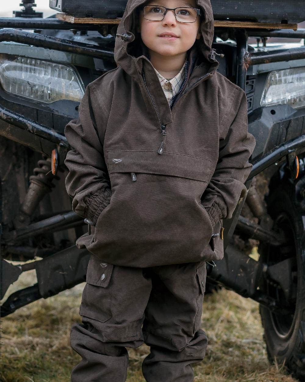 Dark Green Coloured Hoggs of Fife Junior Struther Waterproof Trousers on tractor background