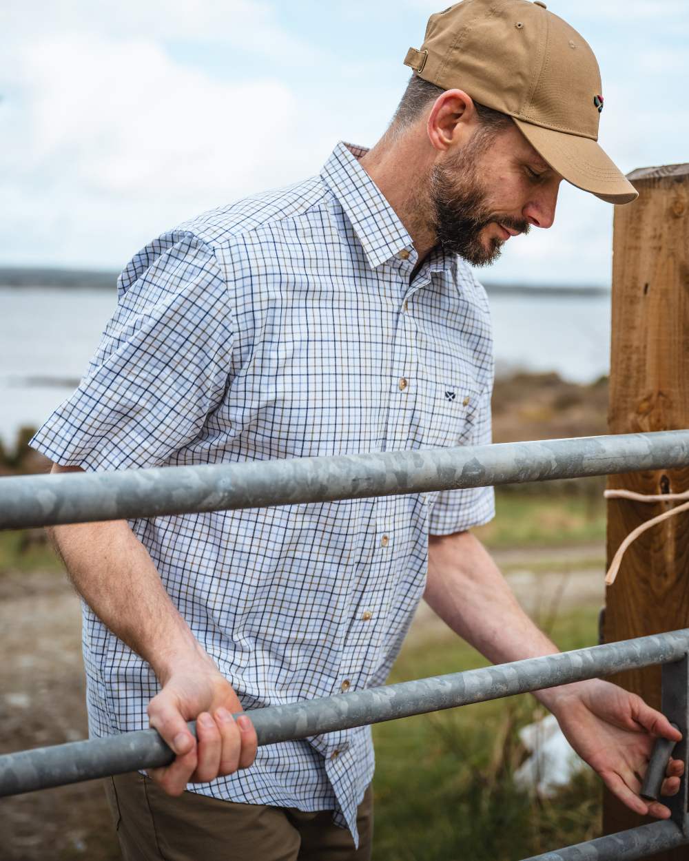 Brown/Blue Coloured Hoggs of Fife Kessock Tattersall Short Sleeved Shirt On A barn Background 