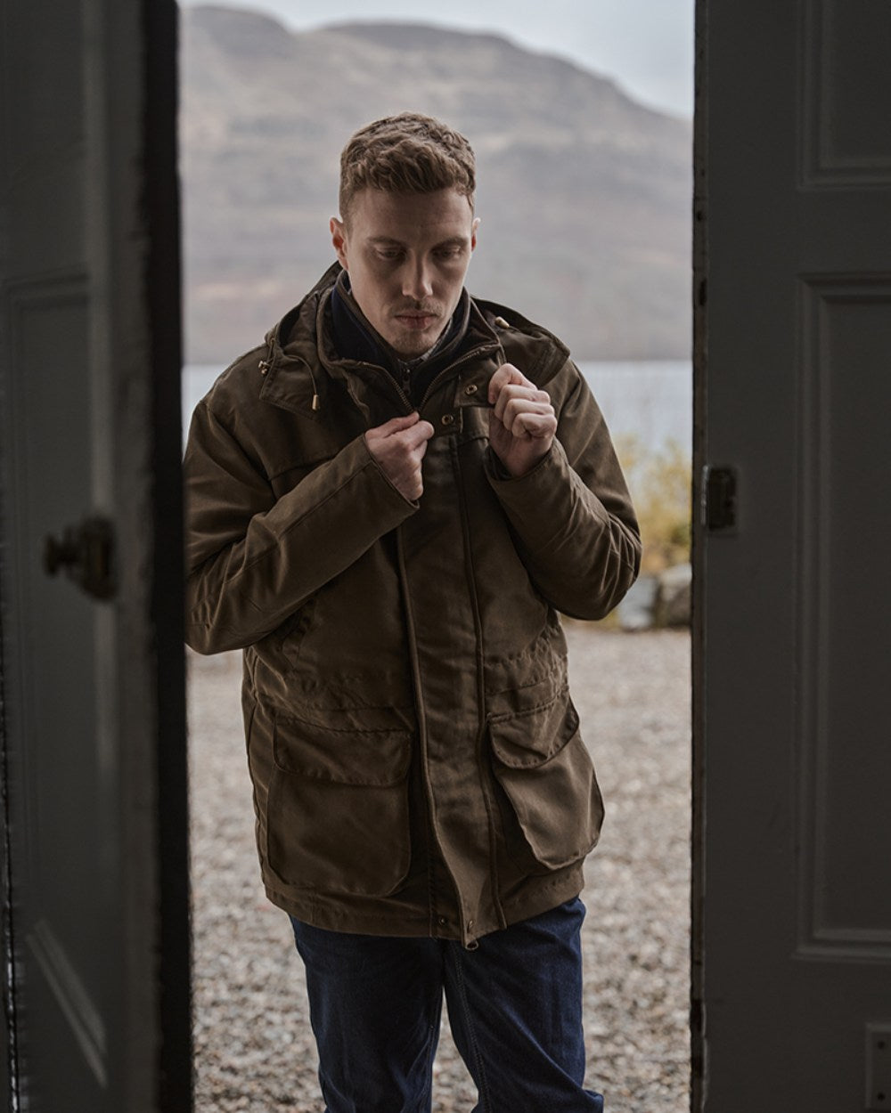 Olive Green Coloured Hoggs of Fife Kincraig Waterproof Field Jacket on mountain background