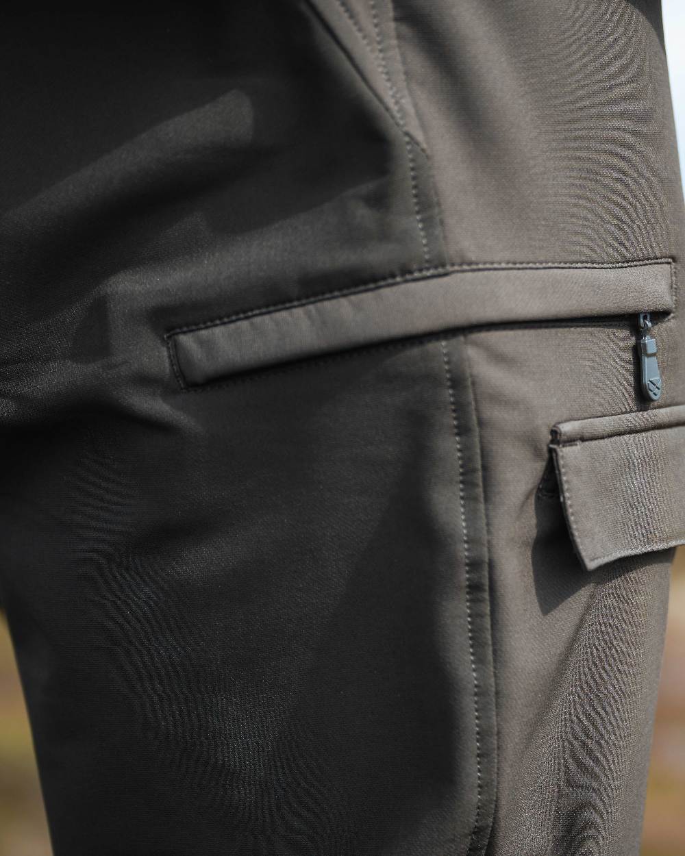 Green Coloured Hoggs of Fife Mens Ardross 4 Way Active Trousers on blurry background