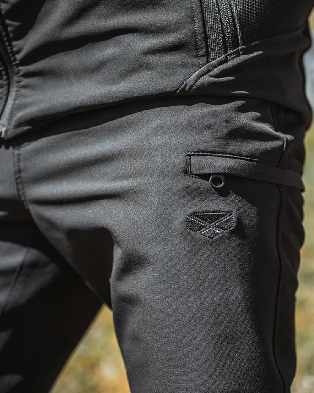 Green Coloured Hoggs of Fife Mens Ardross 4 Way Active Trousers on blurry background