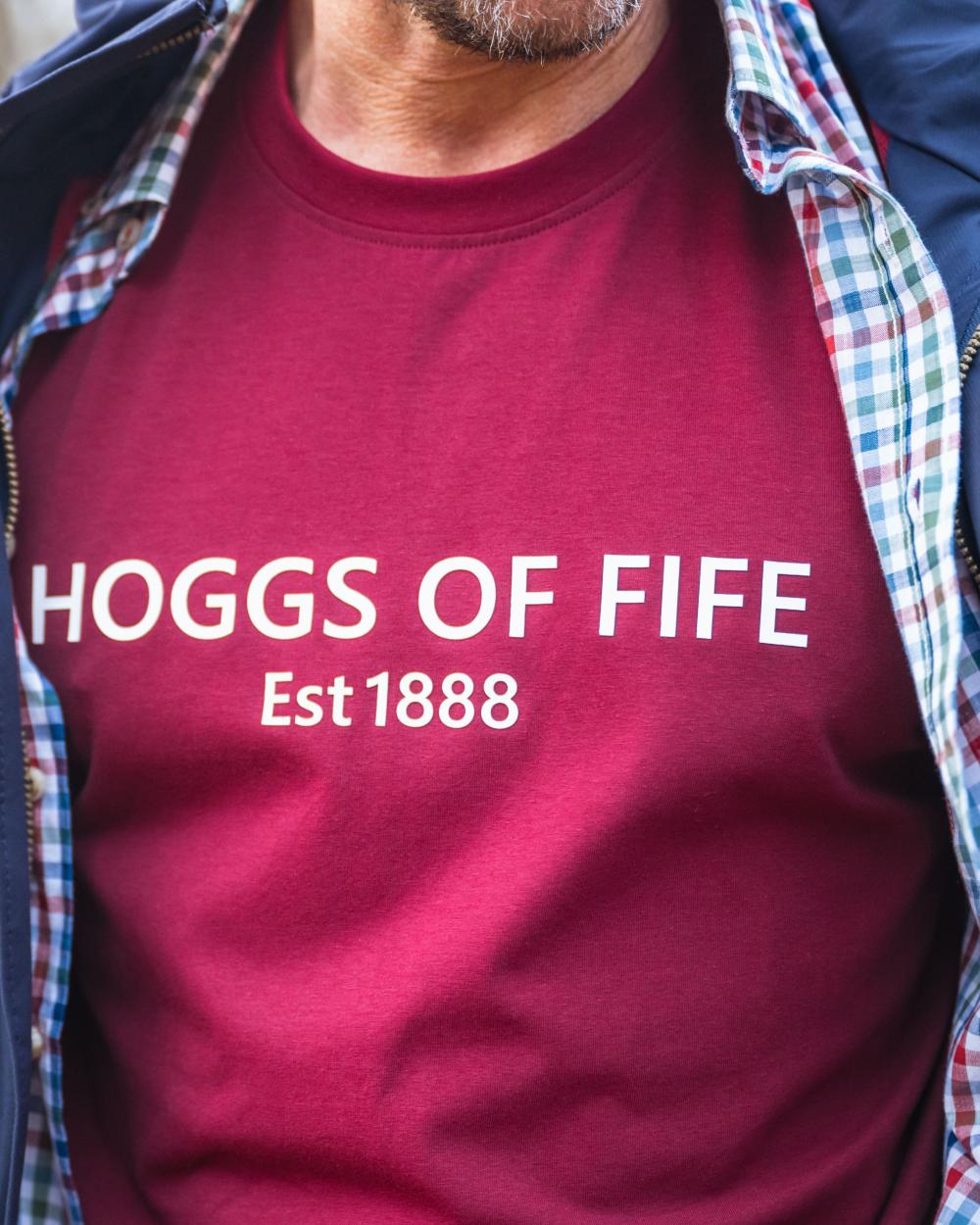 Burgundy Coloured Hoggs of Fife Mens Canonbie Printed T-Shirt on blurry background