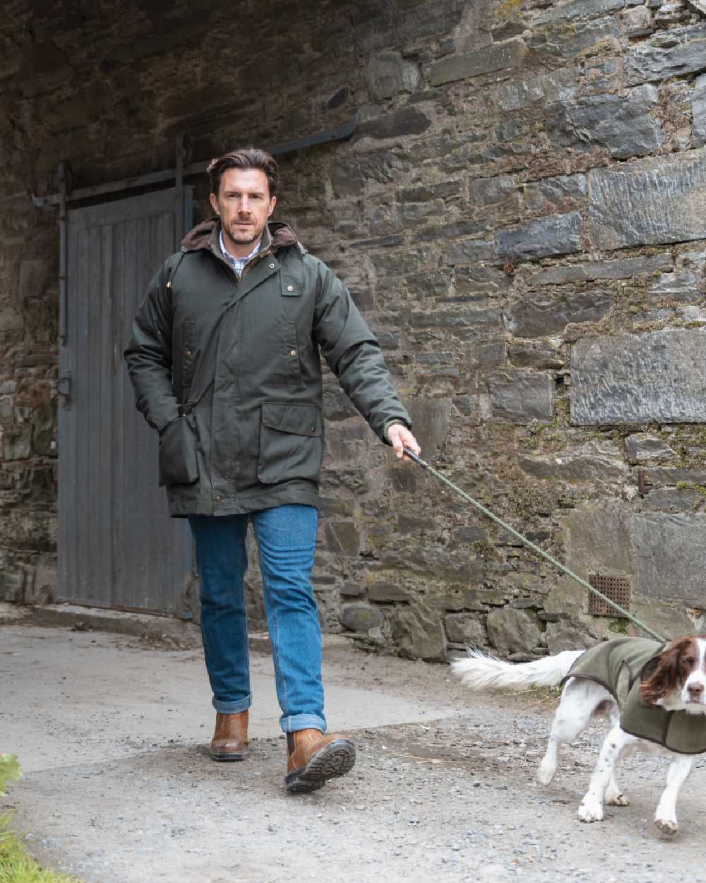 Forest Green Coloured Hoggs of Fife Mens Kelso Waterproof Wax Jacket on outdoor background