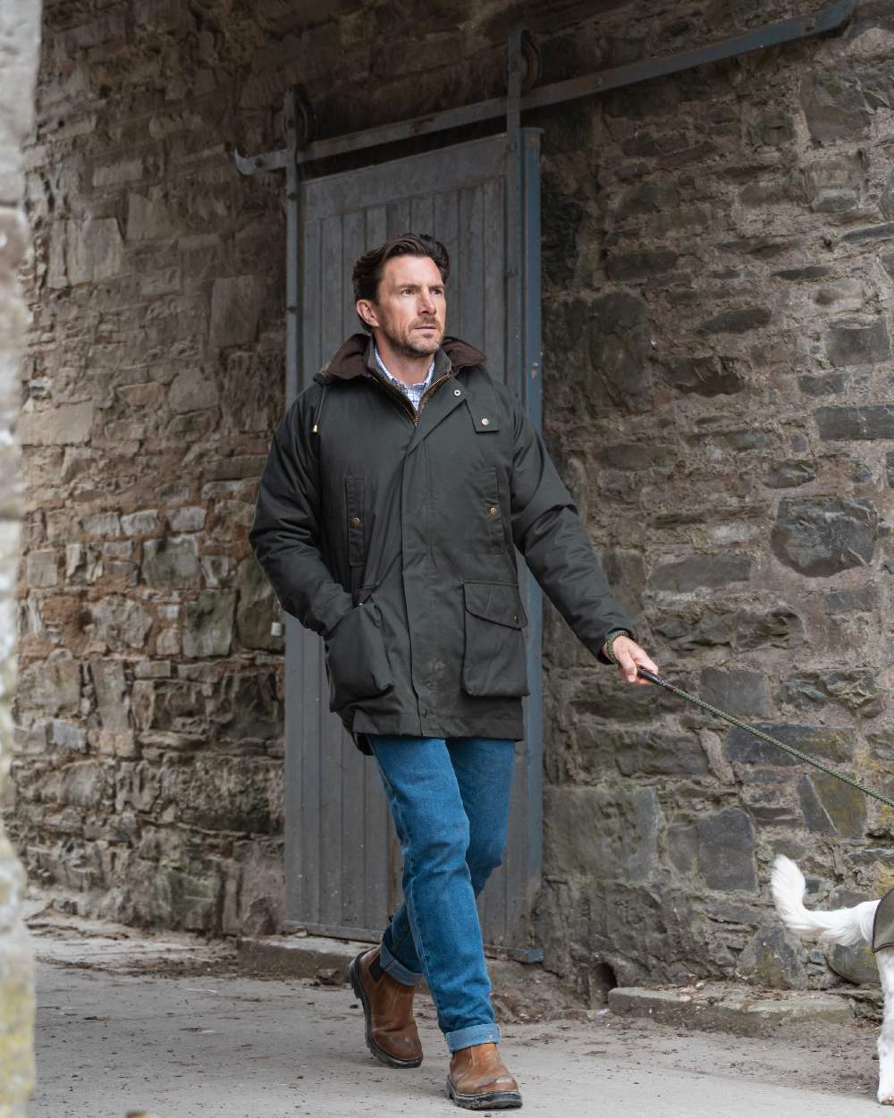 Forest Green Coloured Hoggs of Fife Mens Kelso Waterproof Wax Jacket on outdoor background