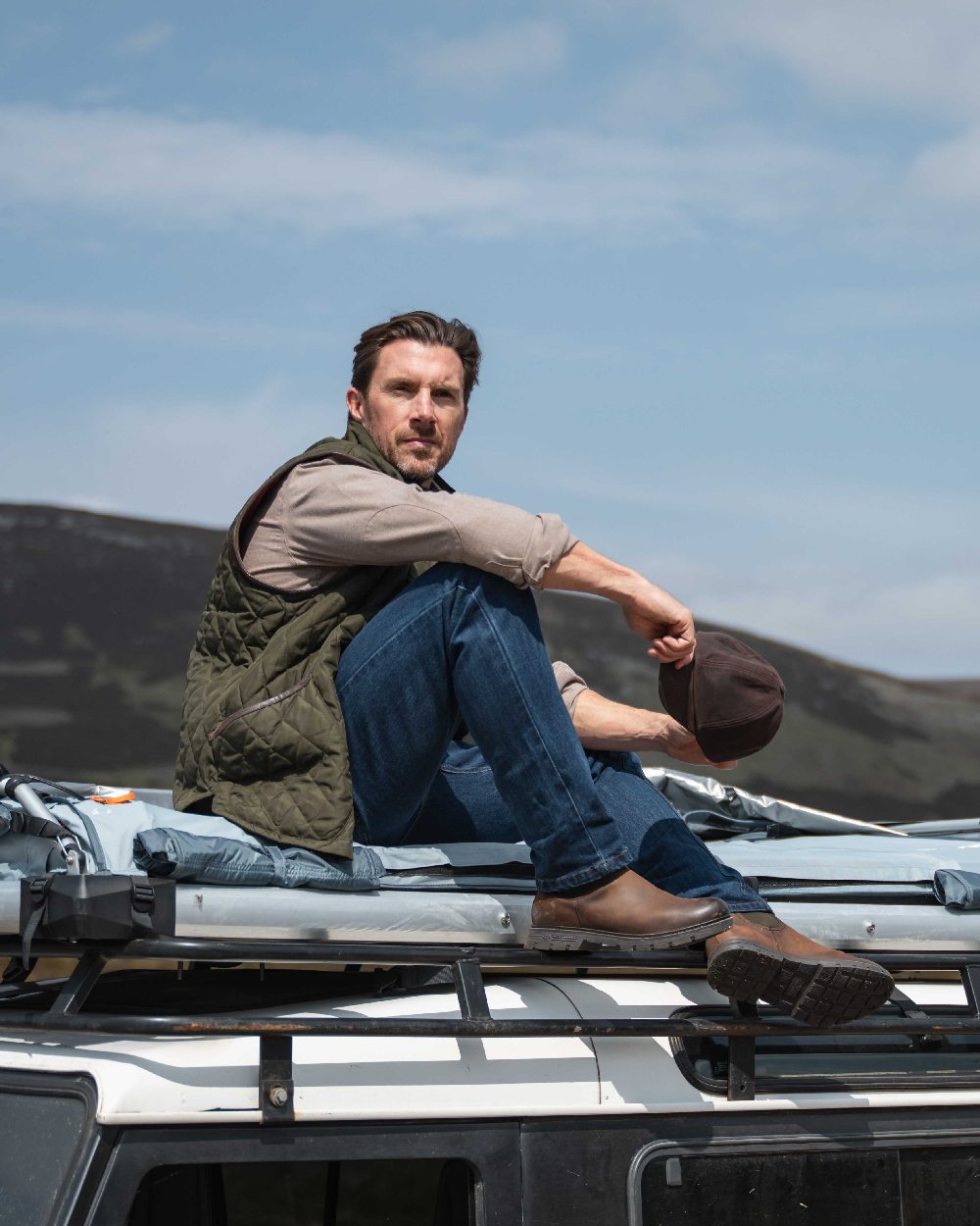 Forest Green Coloured Hoggs of Fife Mens Lindores Quilted Gilet on sky background