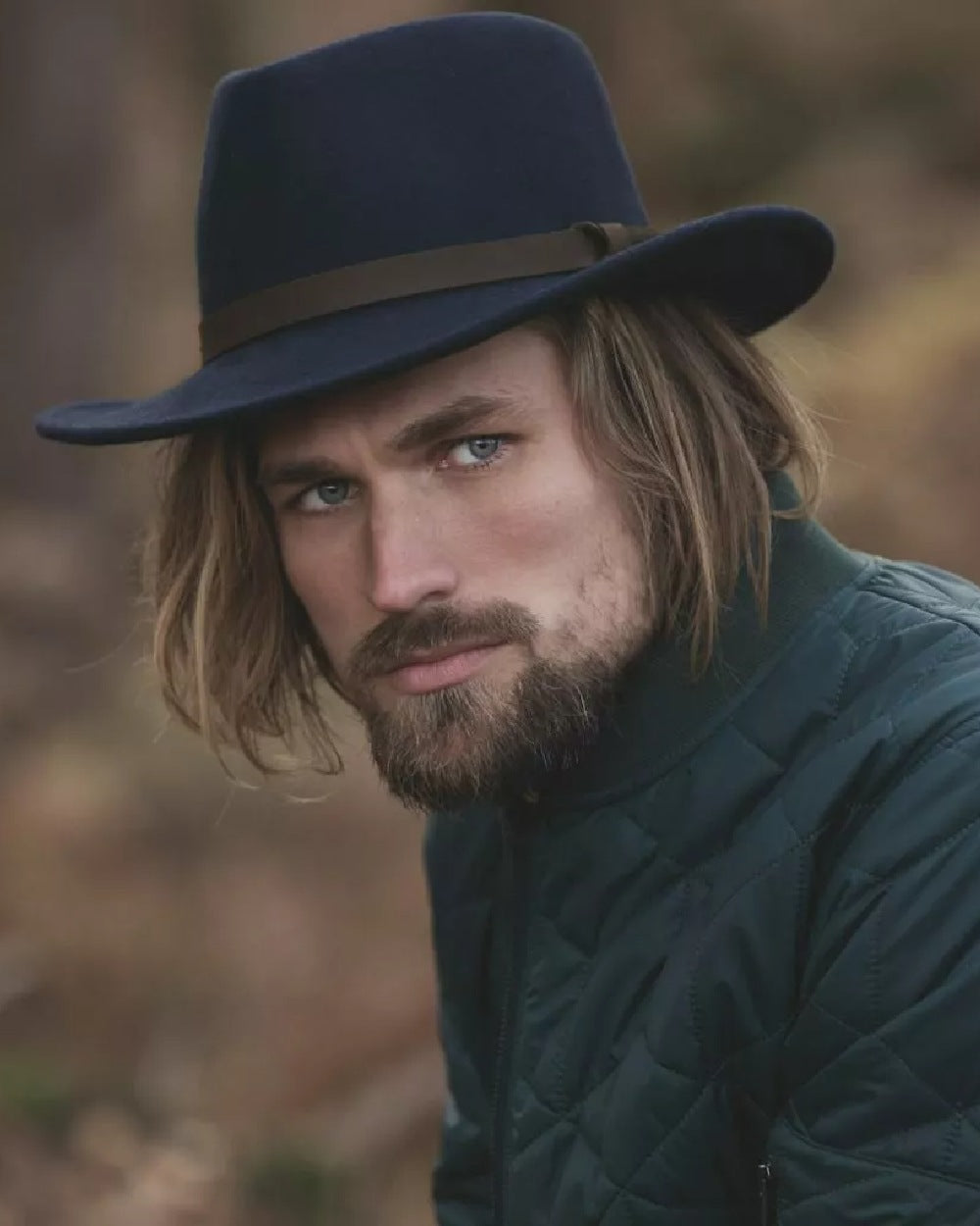 Navy Coloured Hoggs of Fife Perth Crushable Felt Hat on blurry background