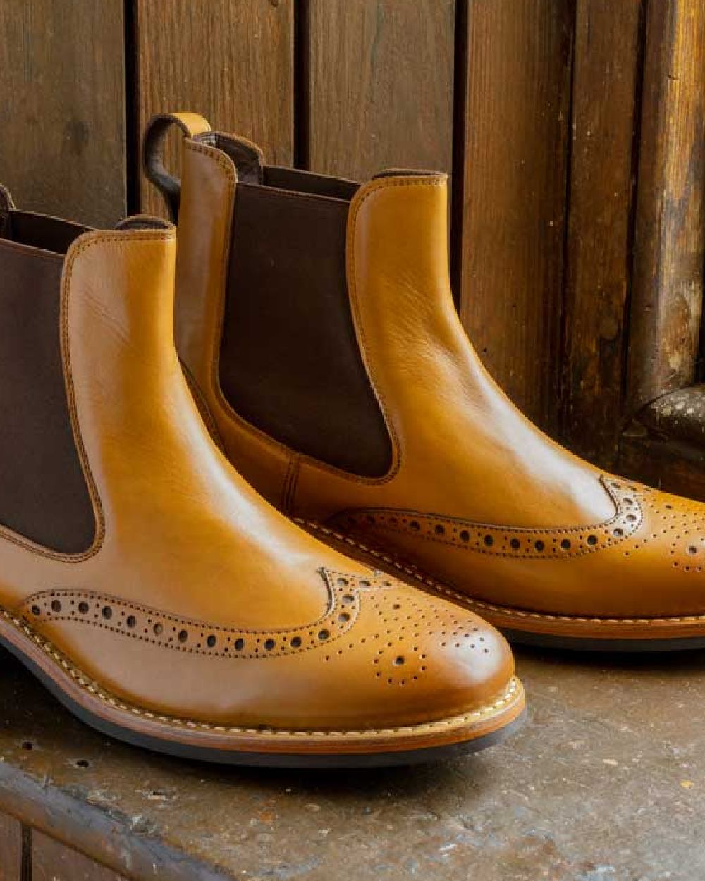 Burnished Tan Coloured Hoggs of Fife Stanley Semi-Brogue Dealer Boots on wood background