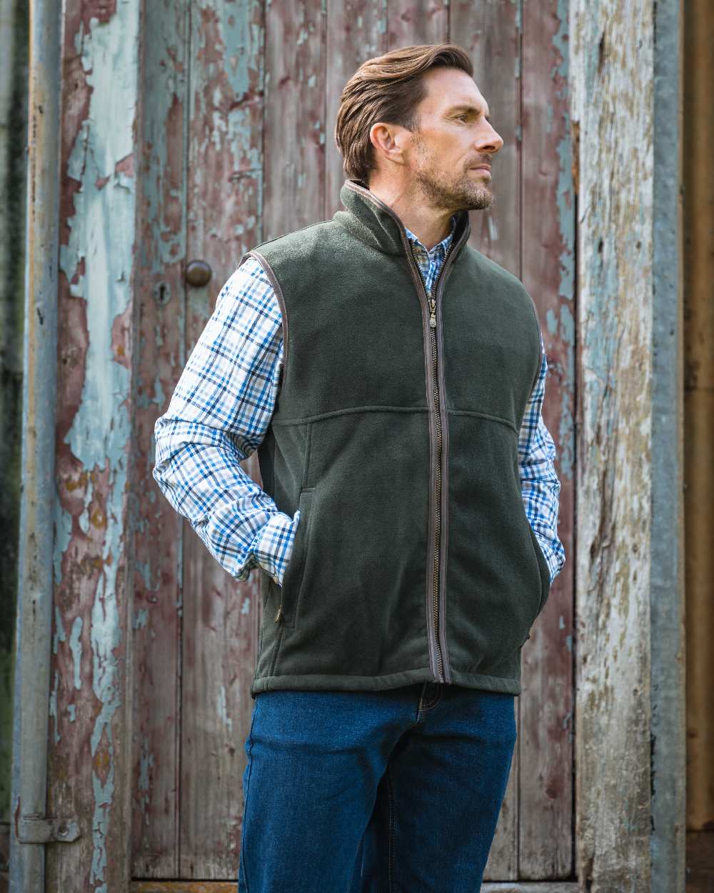 Pine Green coloured Hoggs of Fife Stenton Technical Fleece Gilet on forest background