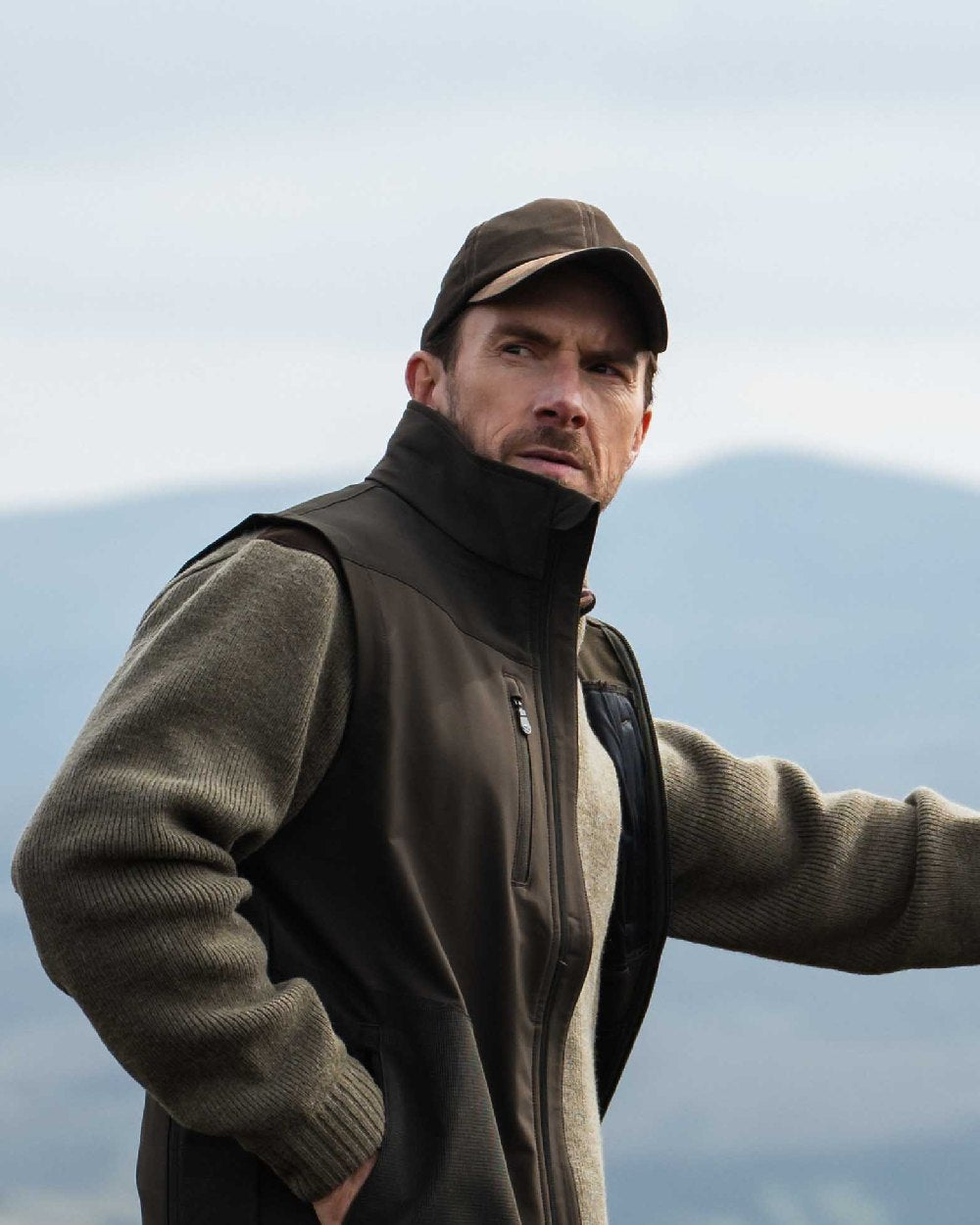 Dark Green coloured Hoggs of Fife Struther Waterproof Baseball Cap on sky background