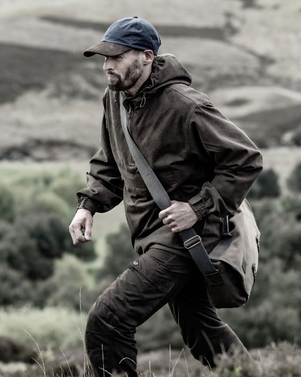 Dark Green coloured Hoggs of Fife Struther Waterproof Field Trousers on forest background